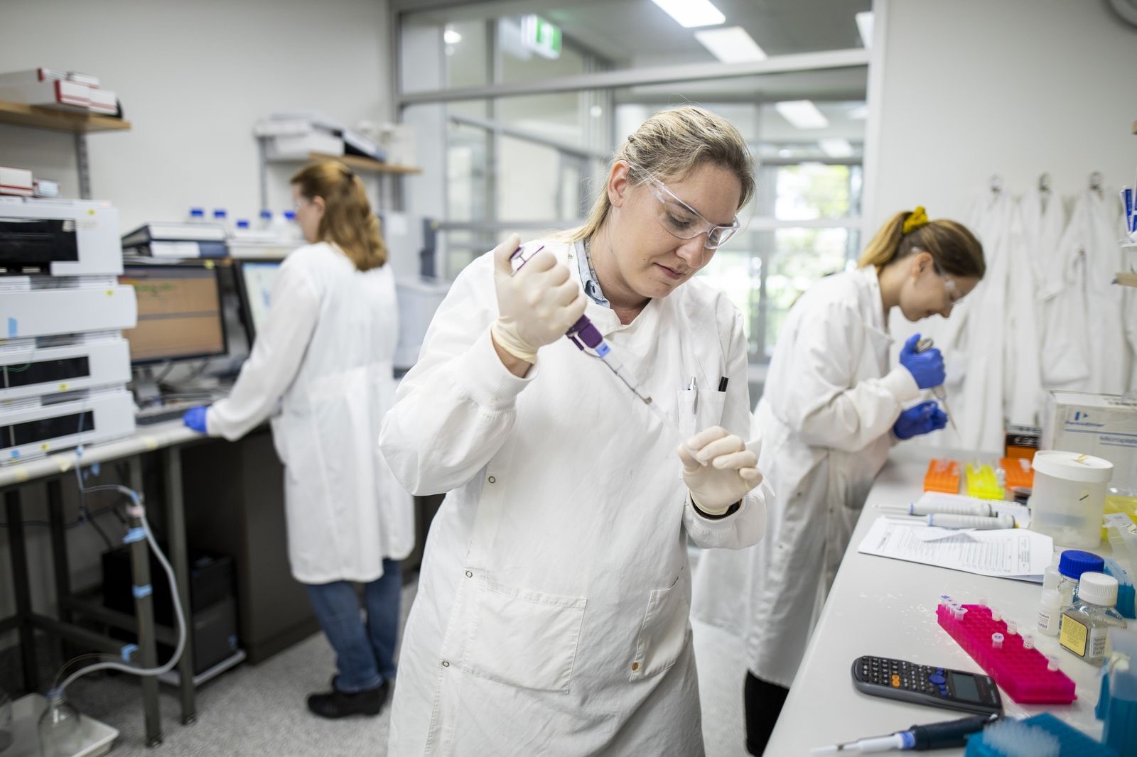 NBF scientists reviewing process records at the laboratory bench